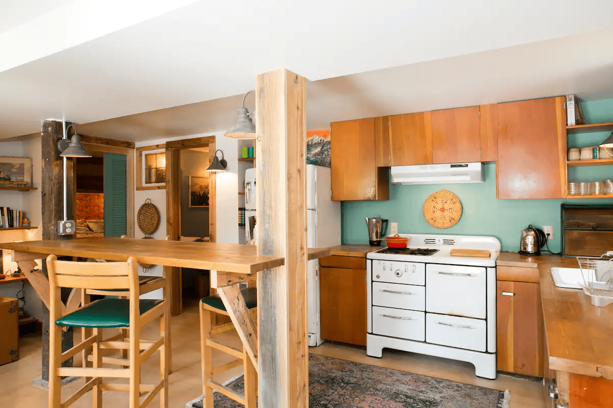a kitchen with a table and chairs